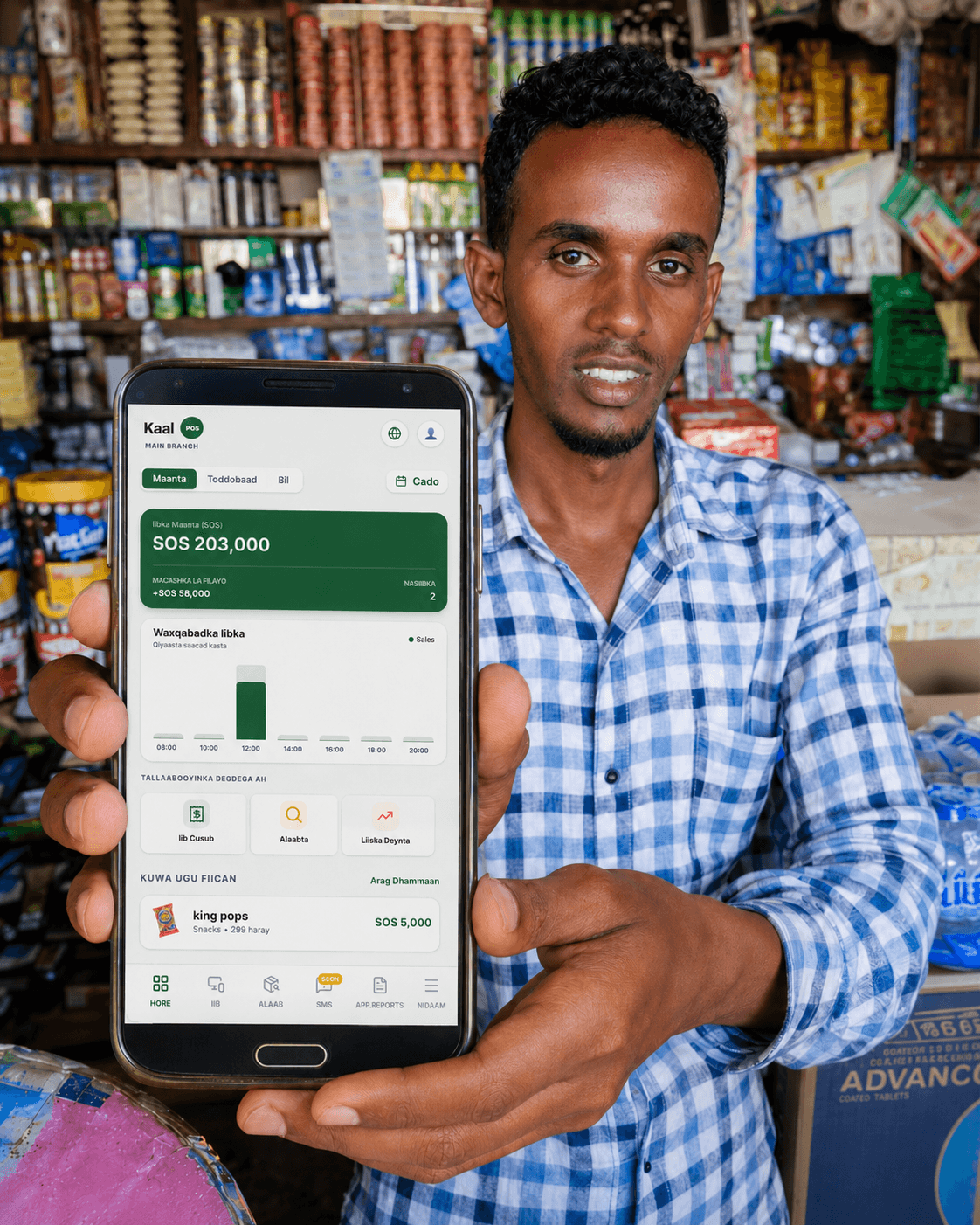 Shop owner showing the KaalPOS mobile dashboard inside a retail store